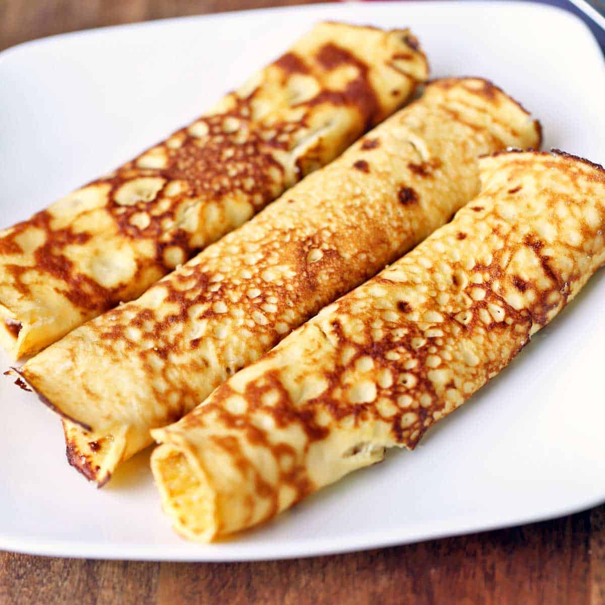 Pannenkoeken are served on a white plate.