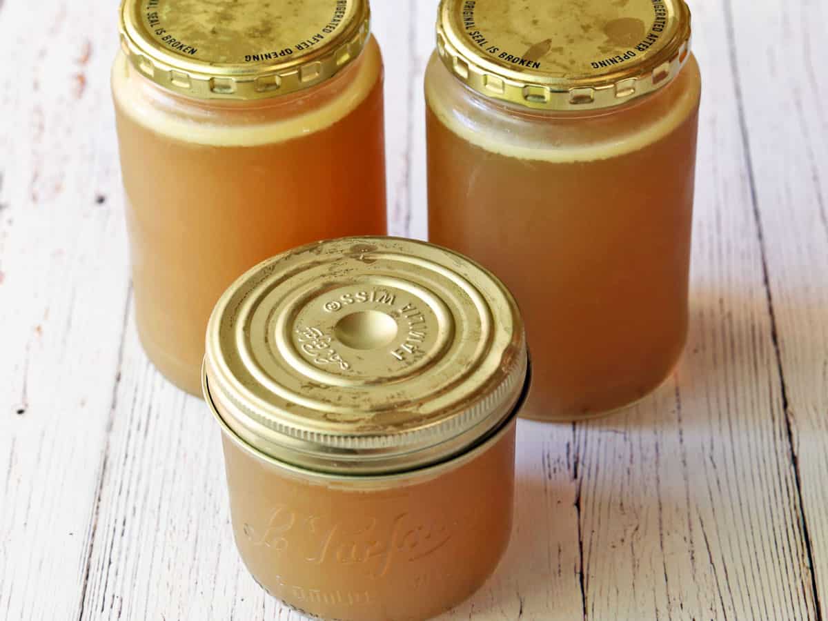 Chicken broth in jars. The fat layer is visible on the top.