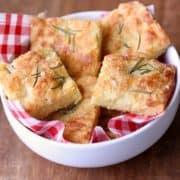 Keto focaccia is served in a white bowl lined with a red checkered napkin.