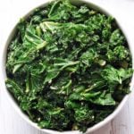 Sauteed kale is served in a white bowl.
