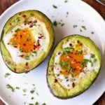 Avocado egg bake is served on a white plate.