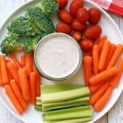 Ranch dressing is served with fresh-cut vegetables.