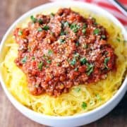 Spaghetti squash with meat sauce is served in a white bowl.