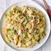 Cabbage stir fry is served with chopsticks.