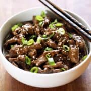 Korean beef is served in a bowl with chopsticks.