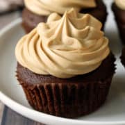 Keto chocolate cupcakes are topped with frosting.