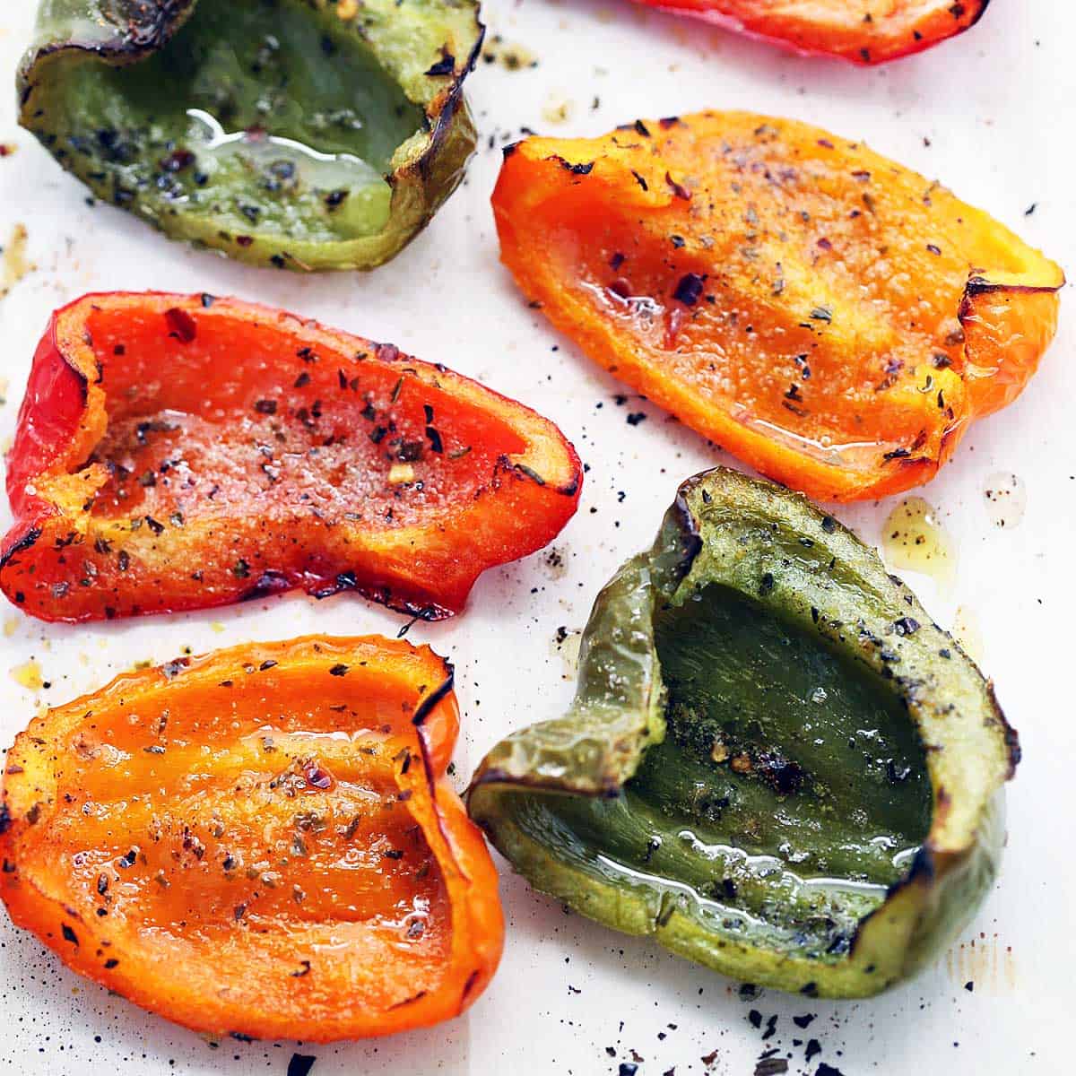 Roasted peppers are served on a white plate.