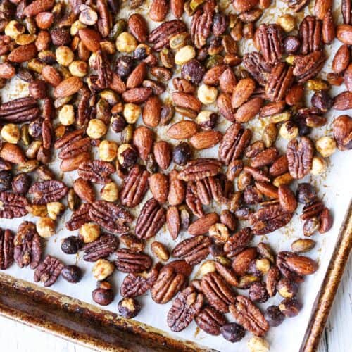Honey-roasted nuts are served on a baking sheet.