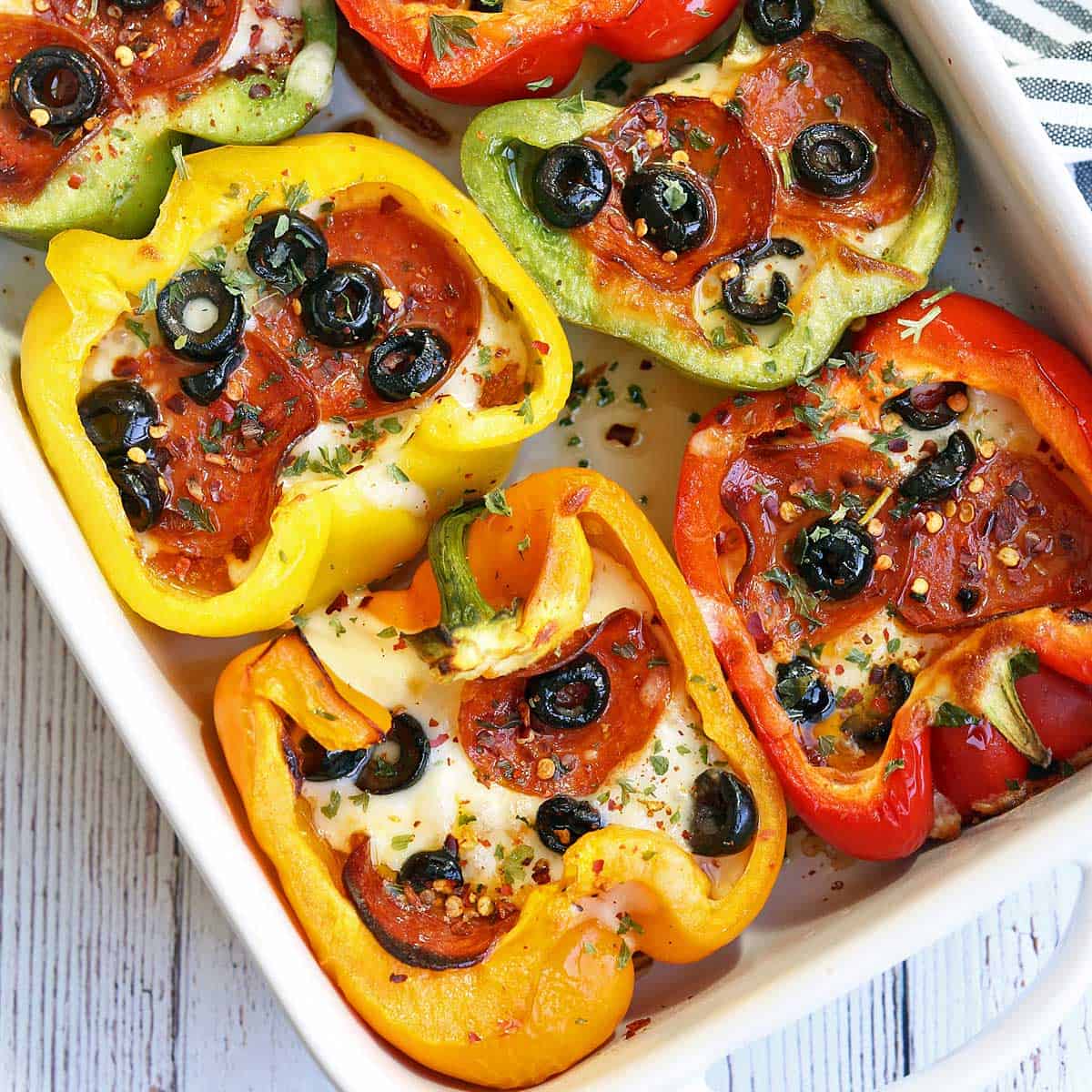 Peppers pizza is served in a white baking dish.