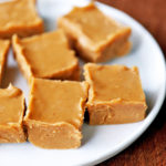 Keto peanut butter fudge squares are served on a white plate.