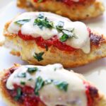 Keto chicken parmesan is served on a white plate.