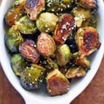 Asian Brussels sprouts are served in a white baking dish.