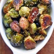 Asian Brussels sprouts are served in a white baking dish.