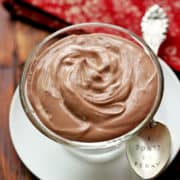 Chocolate yogurt is served with a spoon.