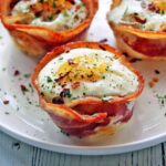 Bacon egg cups are served on a white plate.