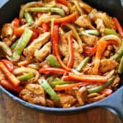 Chicken fajitas are served in a cast-iron skillet.