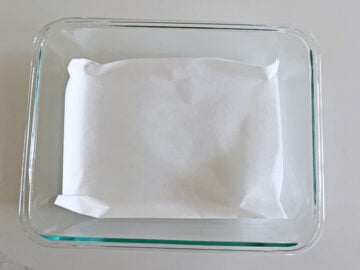 A parchment-lined pan for keto cornbread.