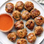 Turkey meatballs are served with a dipping sauce.