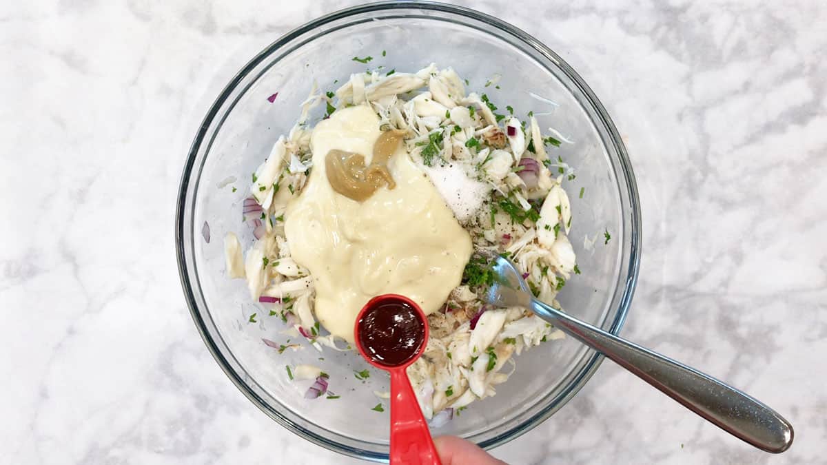 Add mayonnaise to crab salad.