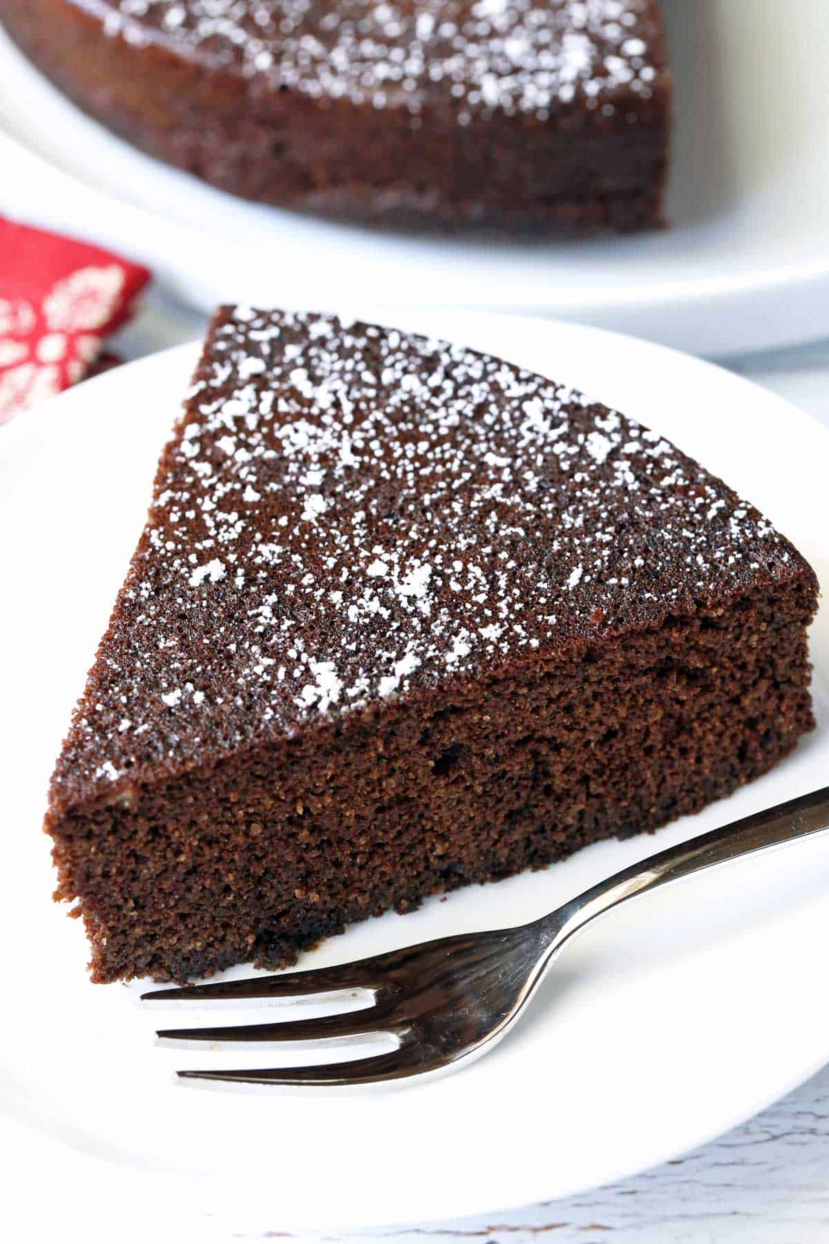 Almond flour chocolate cake is served on a white plate.