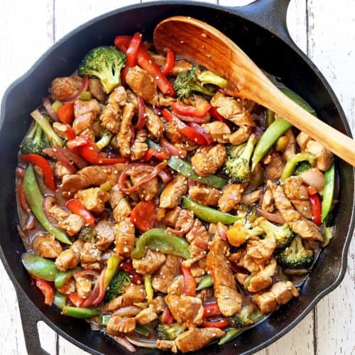 Pork stir fry is served in a cast-iron skillet.