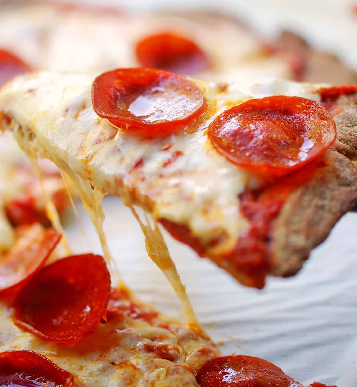 A close-up showing a slice of almond flour pizza crust.