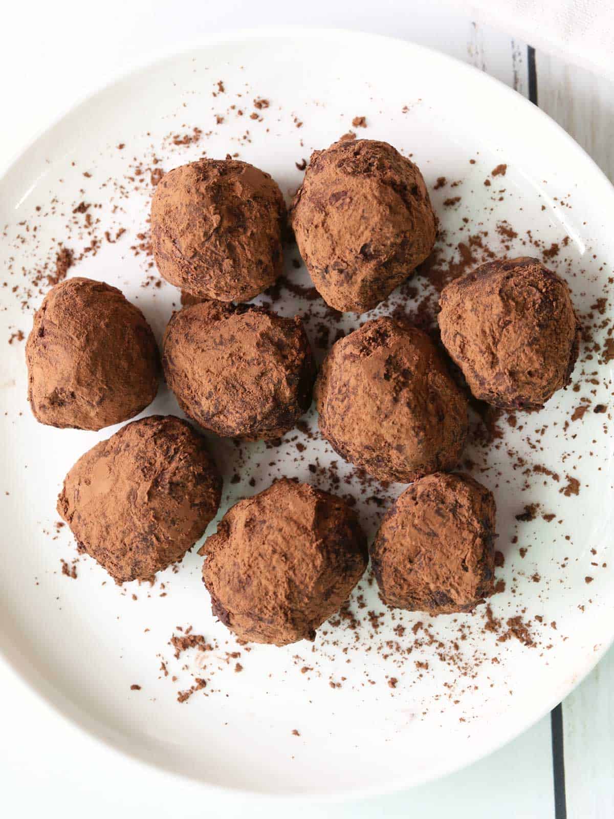 Keto truffles are served on a white plate. 