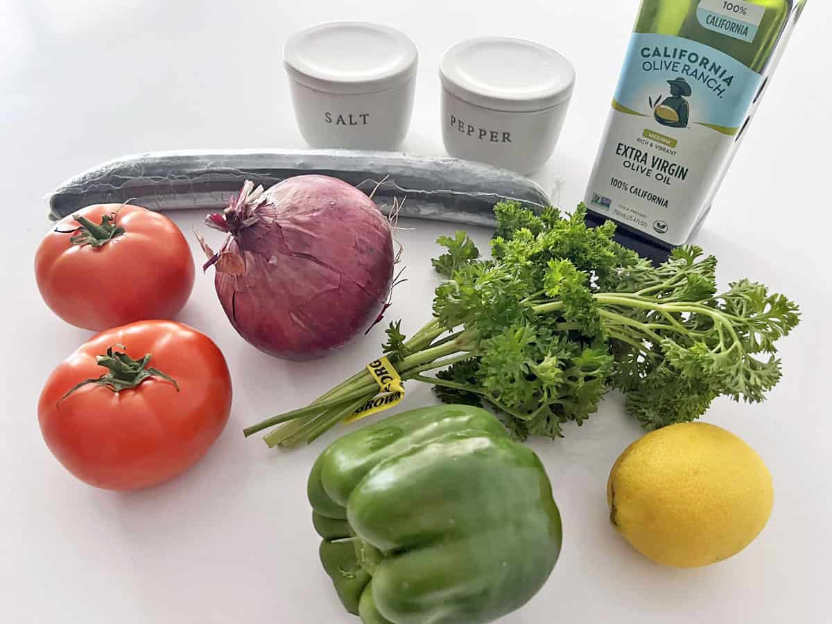 The ingredients needed to make an Israeli salad.