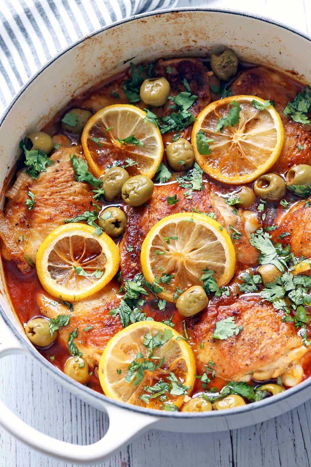 Moroccan chicken is served in a white saucepan.