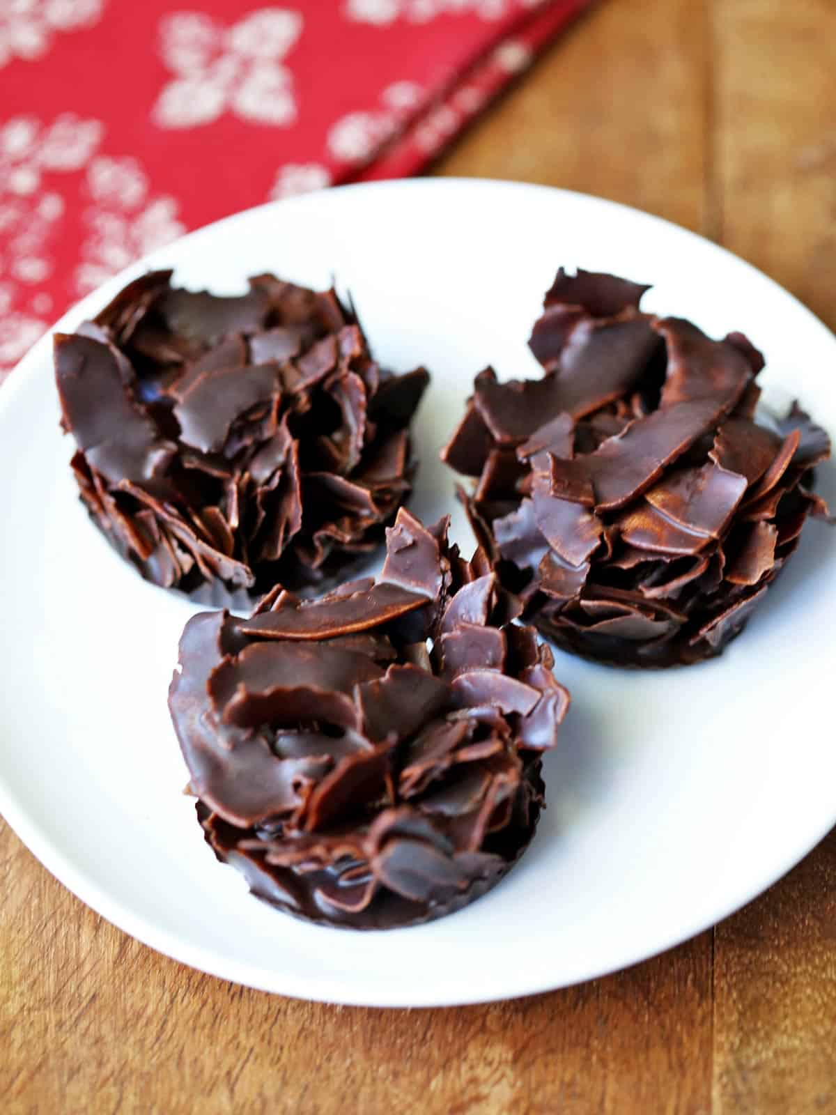 Three coconut clusters served on a white plate.