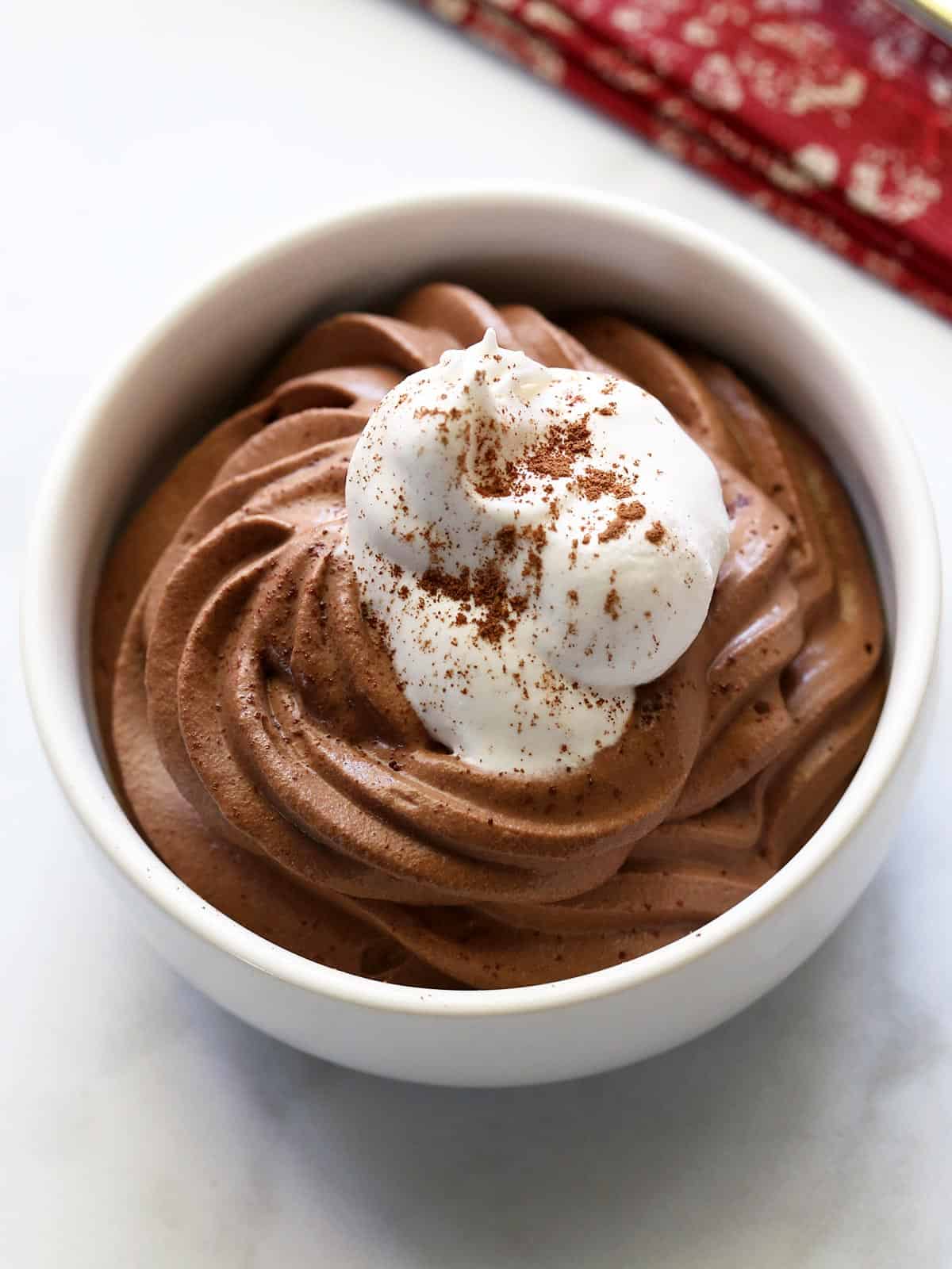 Keto chocolate mousse is served in a white bowl.