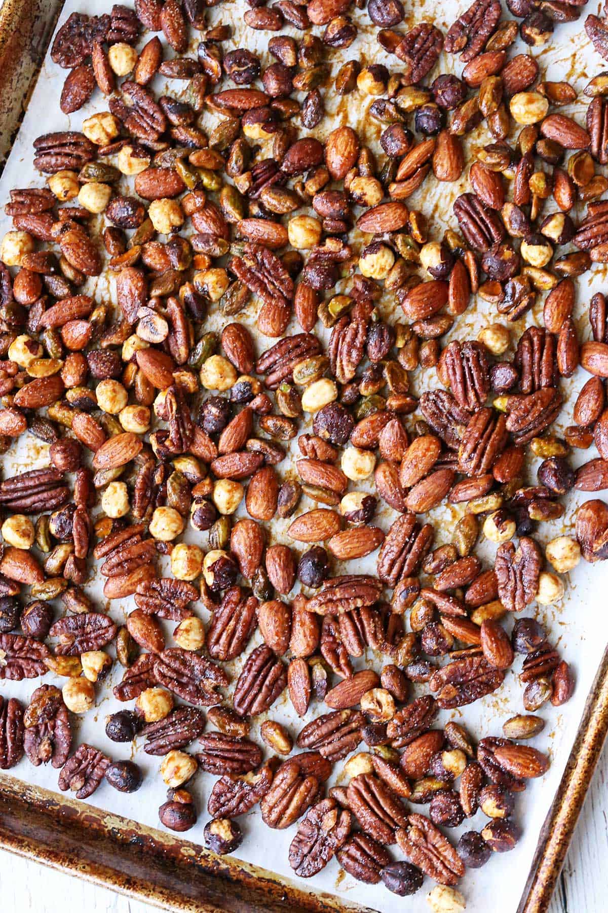Honey-roasted nuts are served on a large baking sheet. 