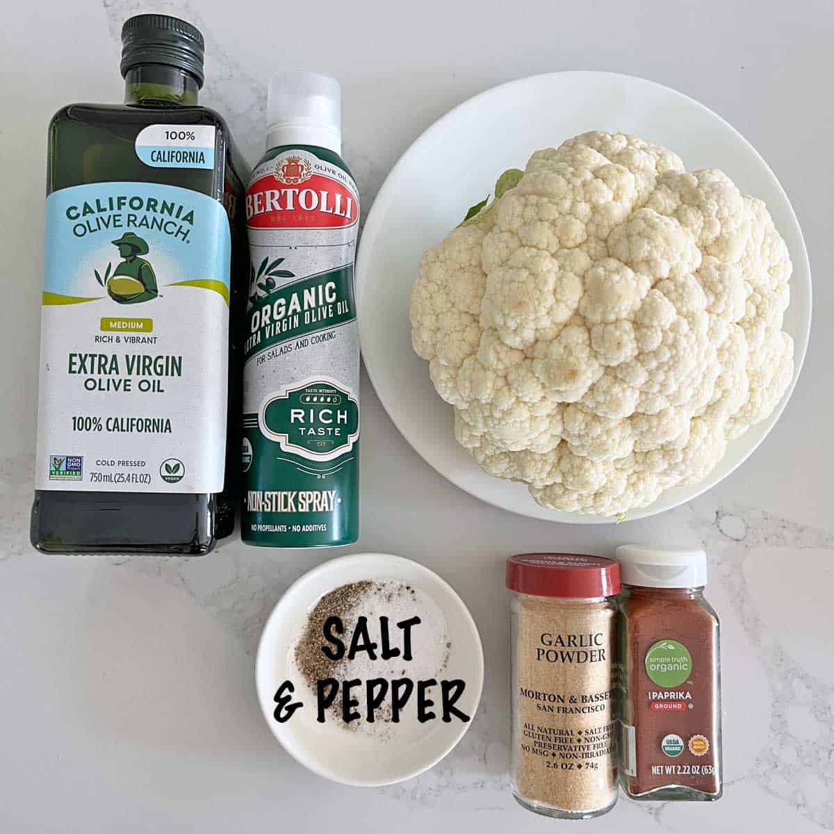 The ingredients needed to make roasted whole cauliflower.