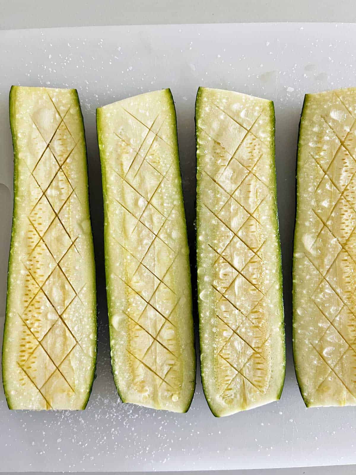 Salted zucchini with water droplets on top.