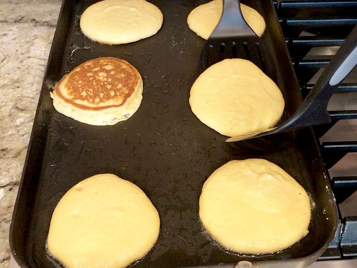 Cooking almond flour pancakes on the griddle.