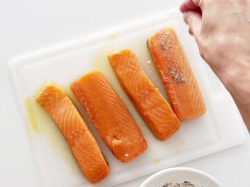 Seasoning the salmon with spices.