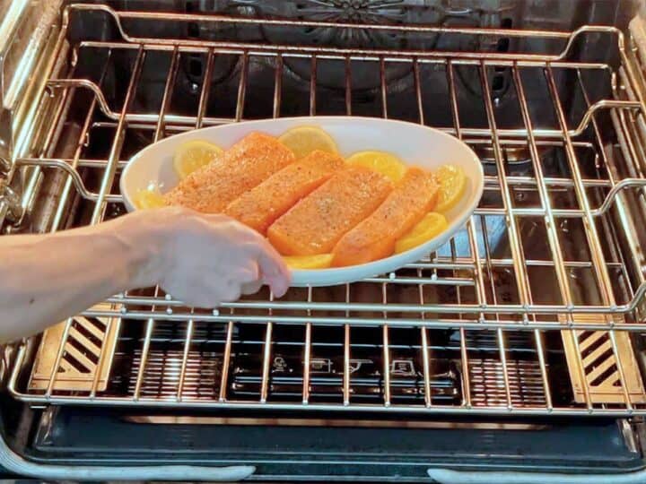 Placing the salmon in the oven.
