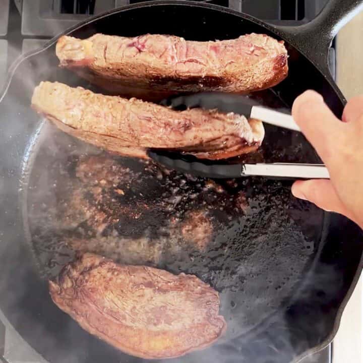 Cooking the edges of the steaks.