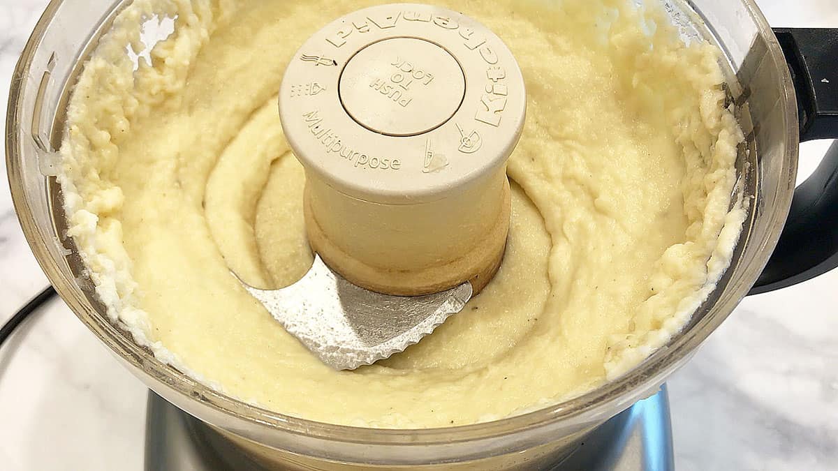 Mashed cauliflower in the food processor's bowl.