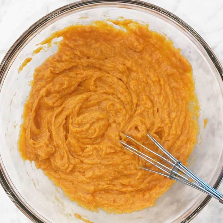 Mixing the pumpkin bread ingredients in a bowl.