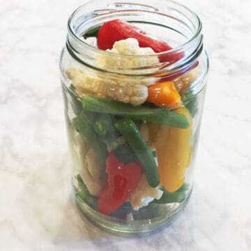 Placing the vegetables in a jar.