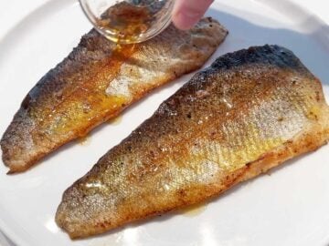 Drizzling the trout with the pan juices.
