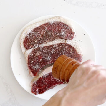 Seasoning picanha steaks.