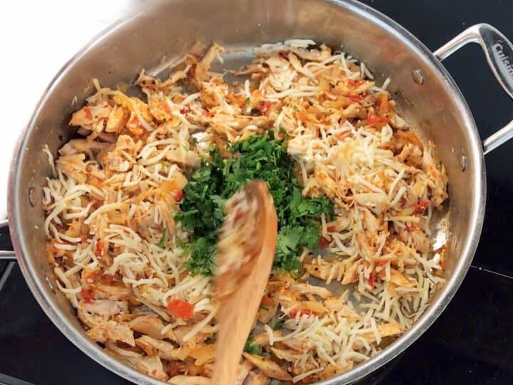 Preparing the filling for the poblanos.