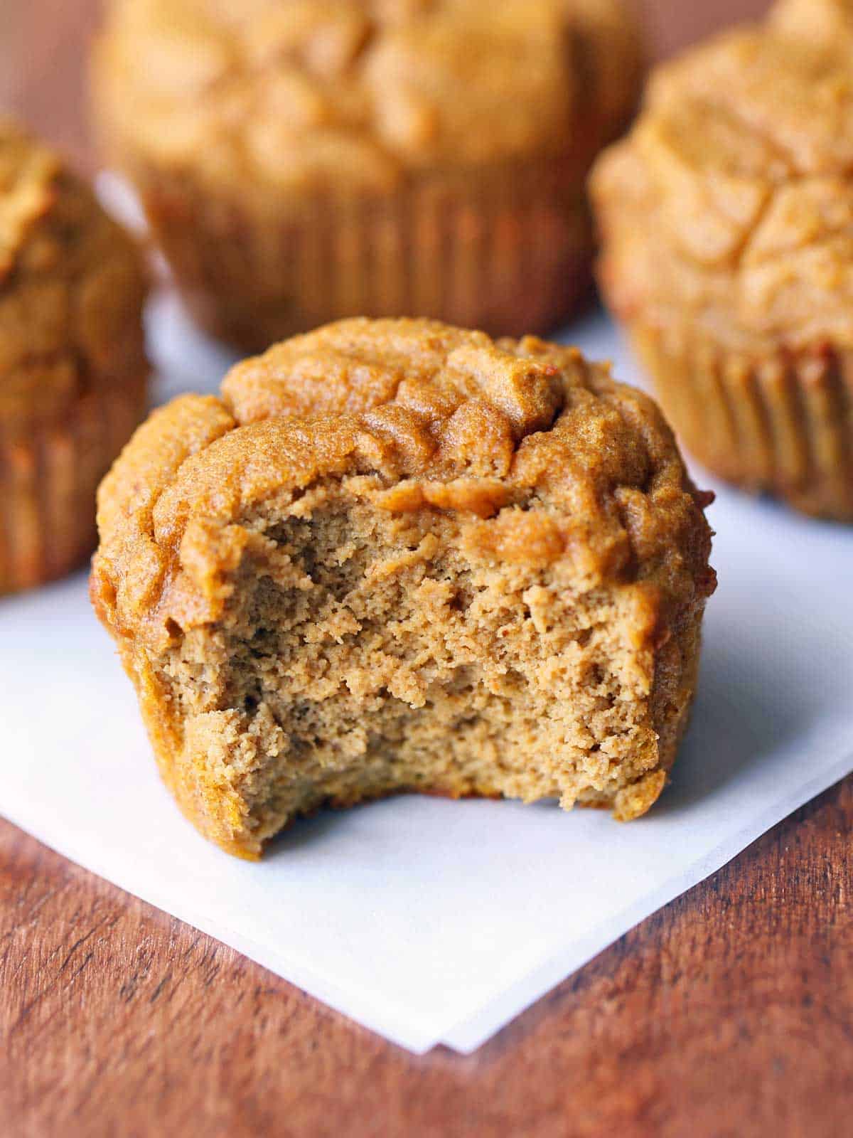 Keto pumpkin muffins on a wooden board.