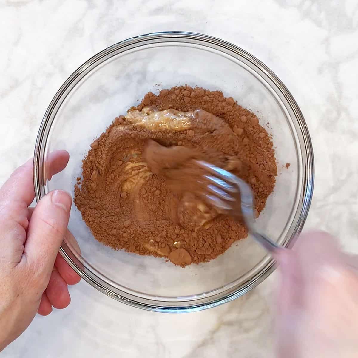 Mixing fat bomb ingredients in a bowl.