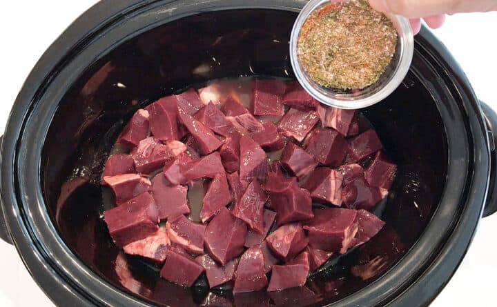 Adding spices to slow cooker.