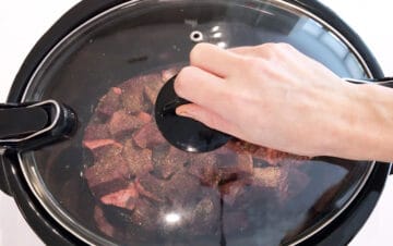 Covering the slow cooker.