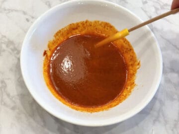 Mixing buffalo sauce.