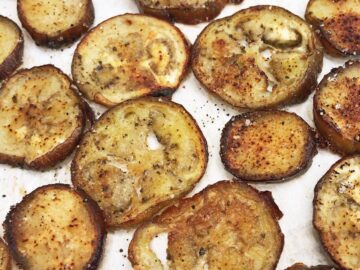 The eggplant chips are ready on the baking sheet.